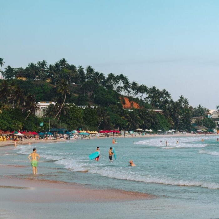 People swimming and relaxing at a tropical beach.