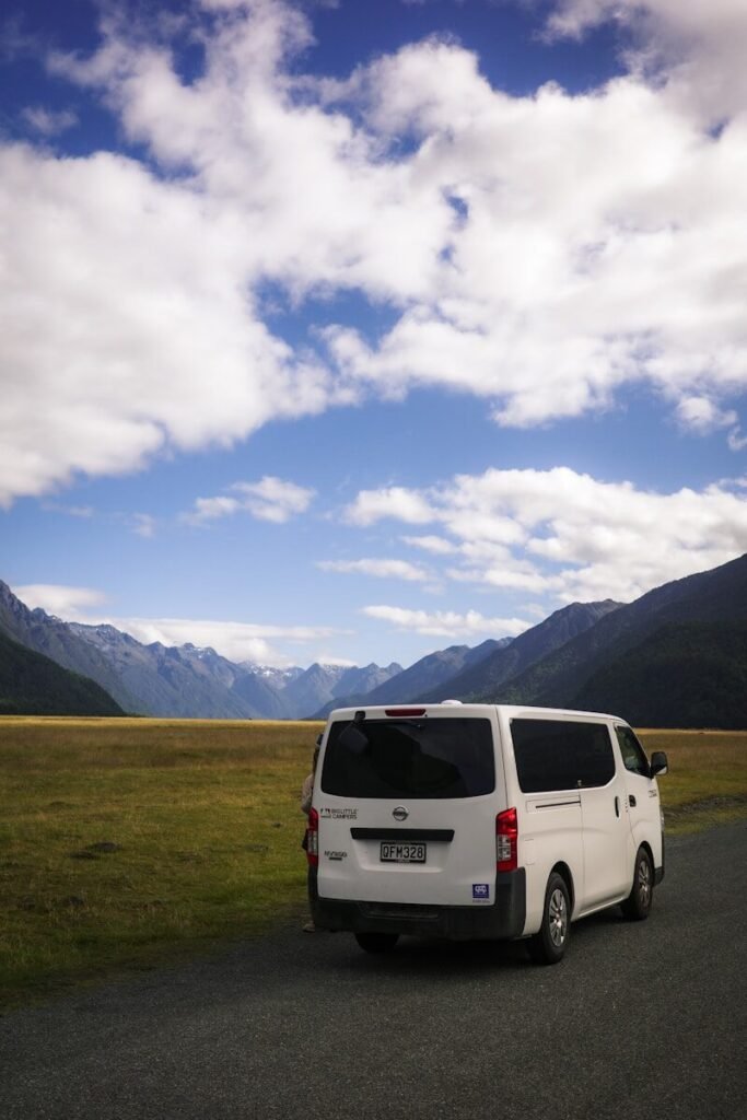 A white van driving down a rural road